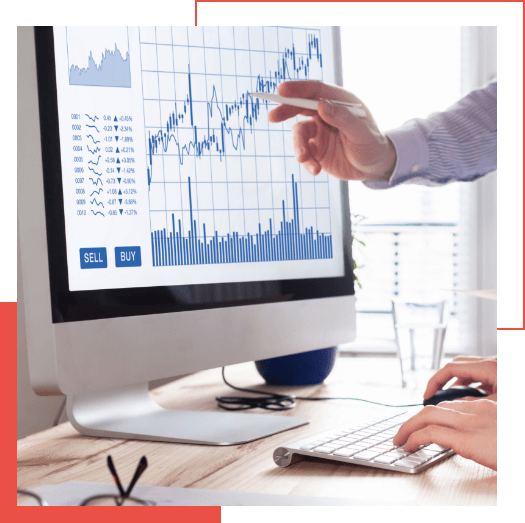  Two people analyzing stock market charts on a computer monitor, with one person pointing at the screen and the other typing on a keyboard—an ideal scene to integrate Adaptive Managed xDR for enhanced decision-making.