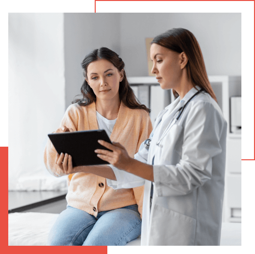  A doctor in a white coat shows a tablet to a seated woman in a peach cardigan, discussing information during the medical consultation about advanced healthcare analytics using Google Chronicle.